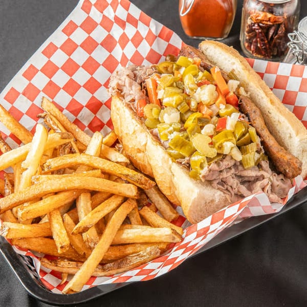 Chicago's Best Italian beef sandwich with giardiniera and a side of golden french fries.